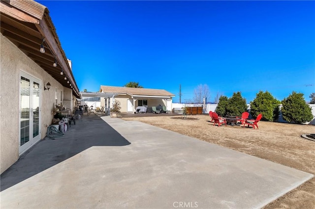 view of patio featuring a fenced backyard and a fire pit