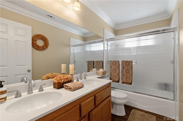 full bath featuring a sink, visible vents, toilet, and ornamental molding