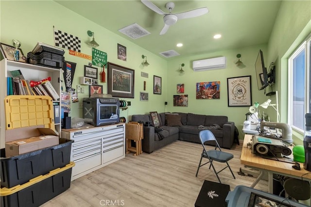 living area featuring recessed lighting, light wood-style floors, an AC wall unit, and ceiling fan