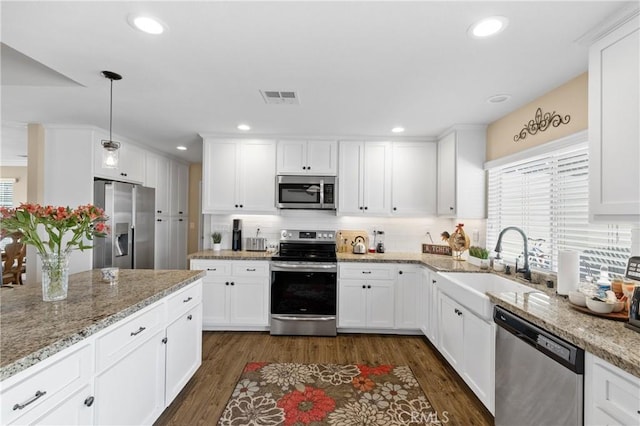 kitchen with a wealth of natural light, visible vents, appliances with stainless steel finishes, and a sink