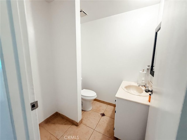 half bathroom featuring visible vents, toilet, vanity, tile patterned flooring, and baseboards