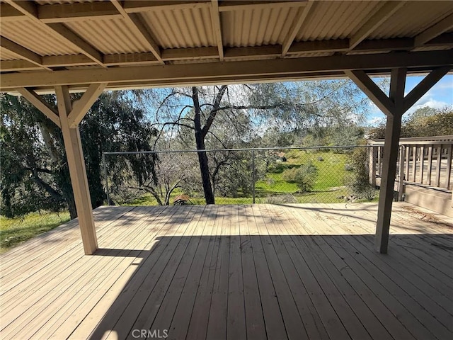 wooden terrace featuring fence