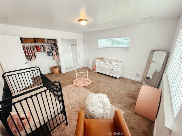 bedroom with carpet, visible vents, and baseboards