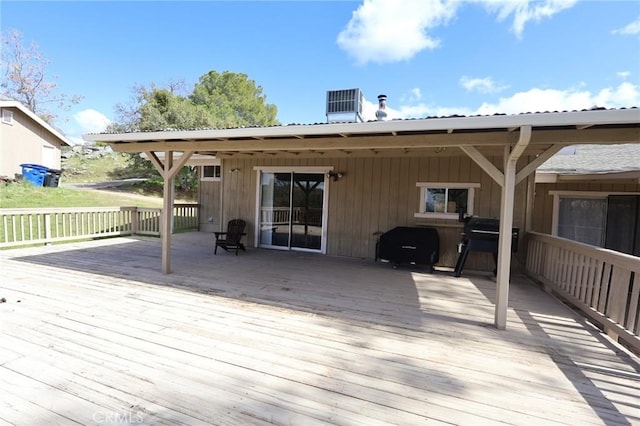 wooden terrace with area for grilling and central air condition unit