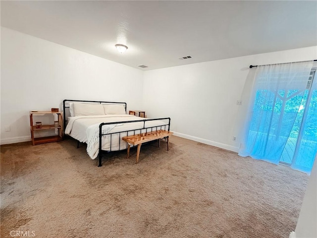 carpeted bedroom with visible vents and baseboards