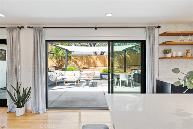 doorway to outside with recessed lighting and wood finished floors