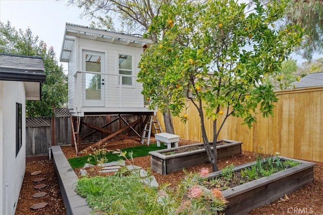 view of yard with a vegetable garden and a fenced backyard