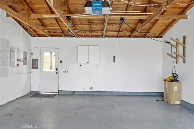 garage featuring electric panel and a garage door opener