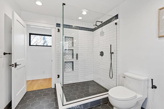 full bath featuring tile patterned flooring, recessed lighting, a shower stall, and toilet