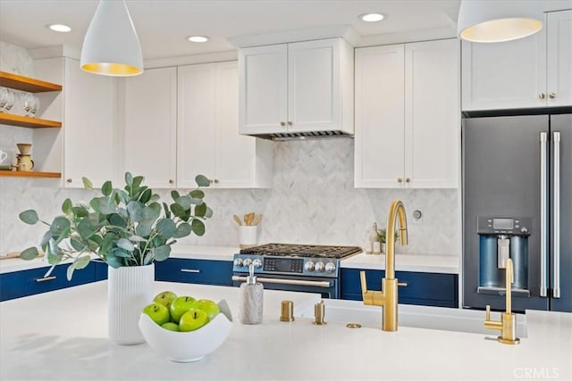 kitchen featuring open shelves, white cabinetry, stainless steel appliances, light countertops, and hanging light fixtures