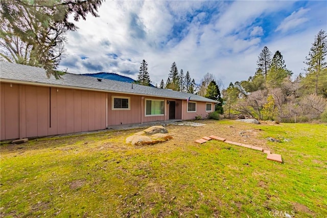 rear view of house with a yard