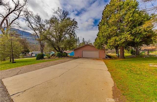 single story home with a garage, driveway, and a front lawn