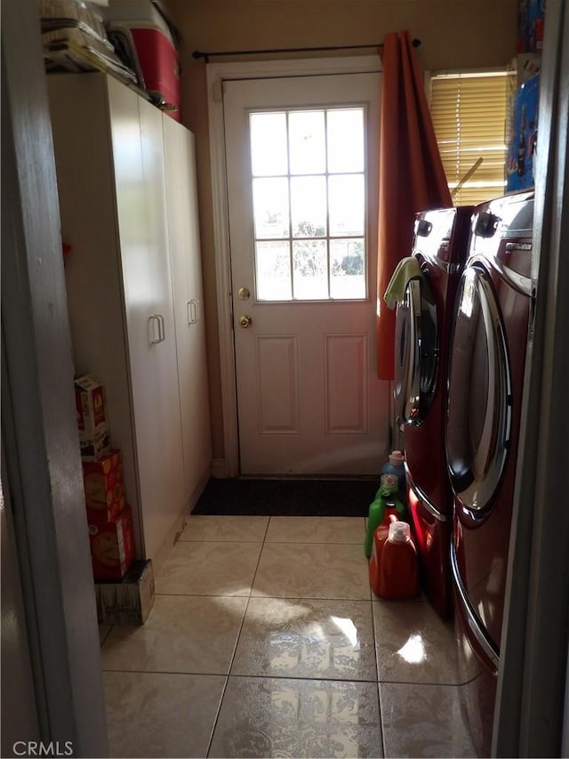 laundry area with light tile patterned floors, laundry area, and washer and clothes dryer