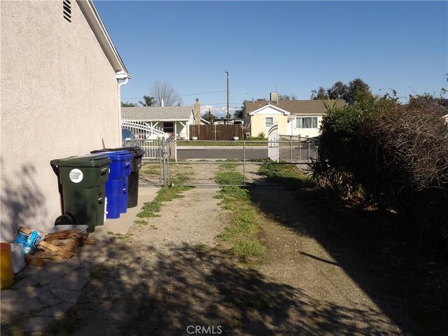 view of yard featuring fence and a gate