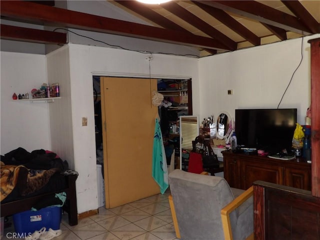 living area with vaulted ceiling with beams and light tile patterned flooring