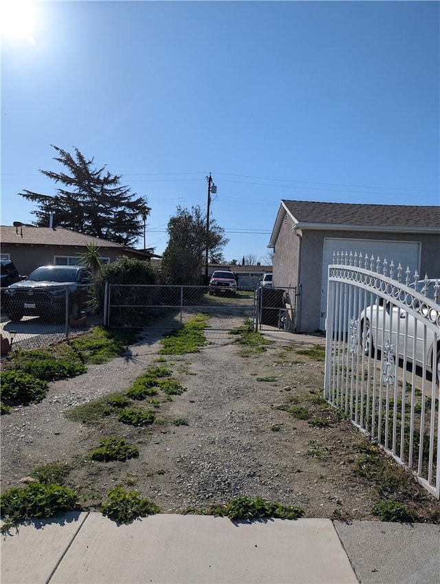 view of road with driveway, a gate, and a gated entry