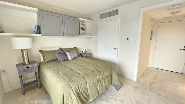 bedroom featuring visible vents and light carpet