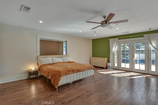 bedroom with access to exterior, wood finished floors, visible vents, and french doors