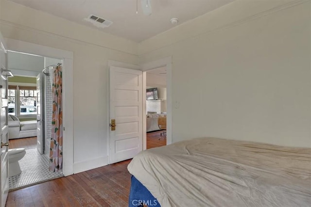 bedroom featuring hardwood / wood-style flooring and visible vents