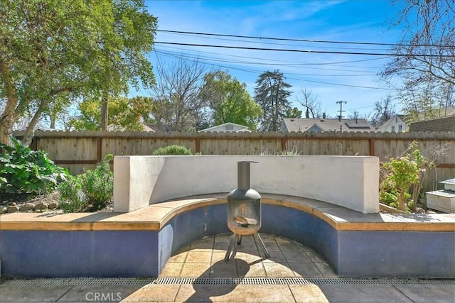 view of front of home with a fenced backyard and a patio area