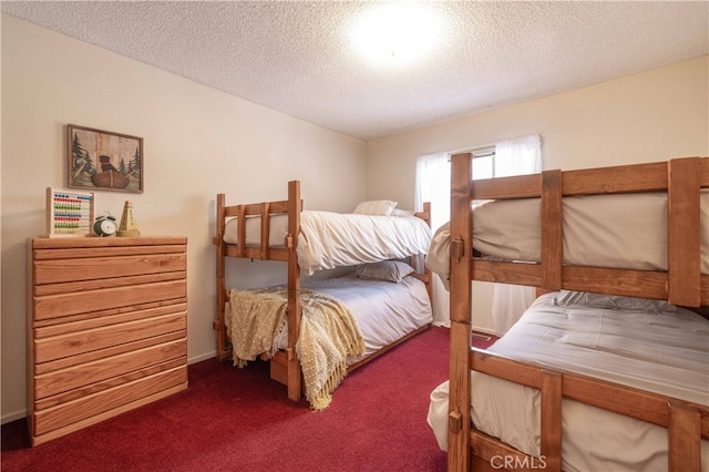 carpeted bedroom featuring a textured ceiling