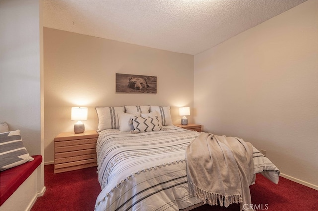 carpeted bedroom featuring a textured ceiling and baseboards