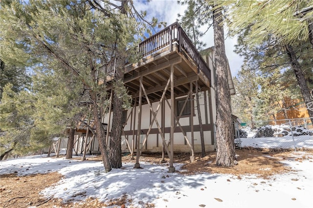 view of side of home with stairway, fence, and a deck