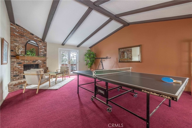 rec room featuring vaulted ceiling with beams, a brick fireplace, carpet flooring, and french doors