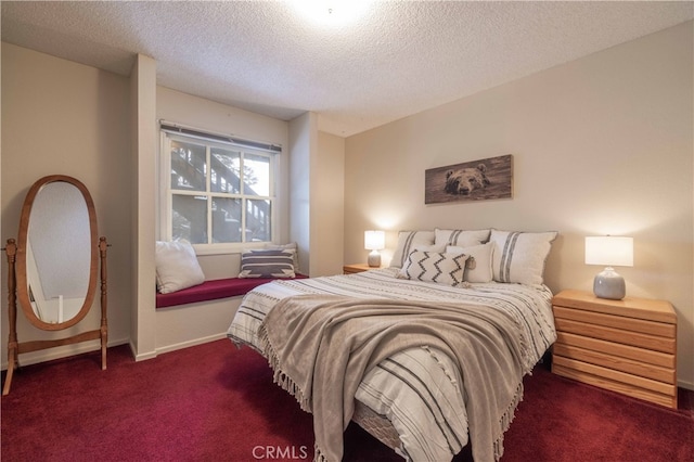 bedroom with baseboards, dark carpet, and a textured ceiling