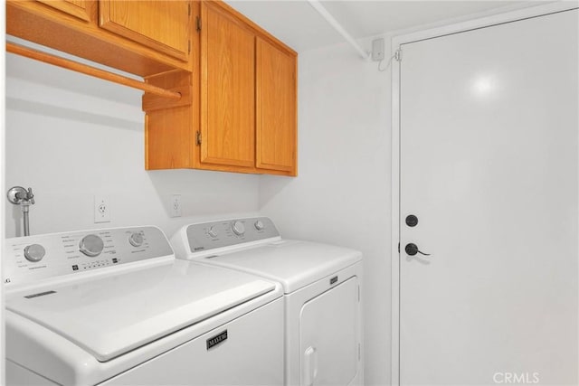 laundry area with cabinet space and separate washer and dryer