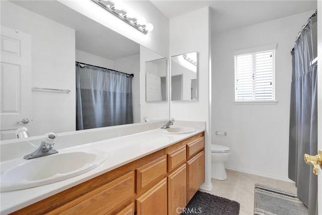 bathroom featuring tile patterned floors, a sink, toilet, and double vanity