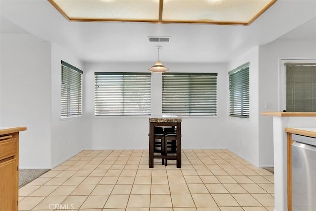 interior space with light tile patterned flooring, plenty of natural light, and visible vents