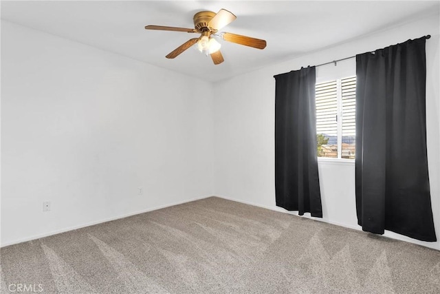 spare room featuring ceiling fan and carpet floors