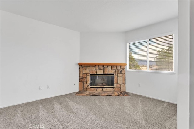 unfurnished living room with carpet and a fireplace