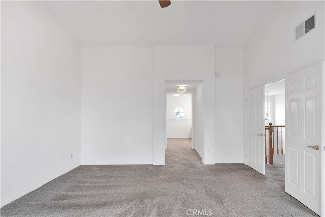 unfurnished room featuring carpet and visible vents