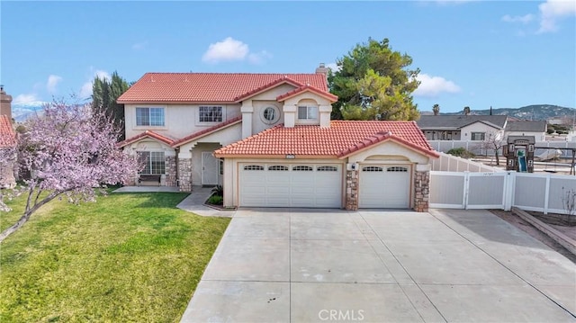 14783 Wilson Pl, Hesperia, CA 92345 - mediterranean / spanish-style home featuring a chimney, stucco siding, stone siding, driveway, and a tiled roof