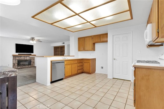 kitchen with dishwasher, light countertops, ceiling fan, and range with gas stovetop