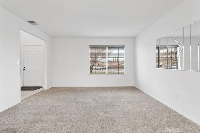 carpeted spare room with visible vents