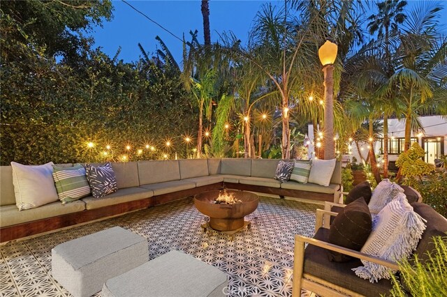 view of patio featuring an outdoor living space with a fire pit