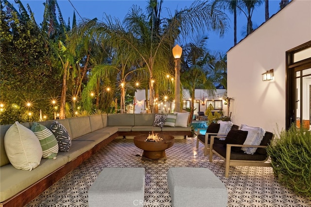 view of patio featuring an outdoor living space with a fire pit