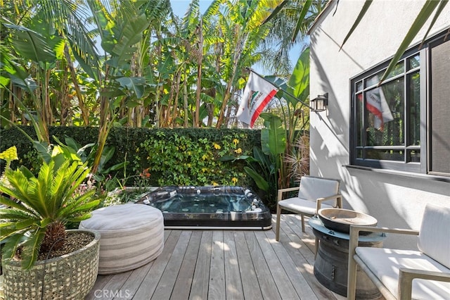 wooden deck featuring an outdoor hot tub