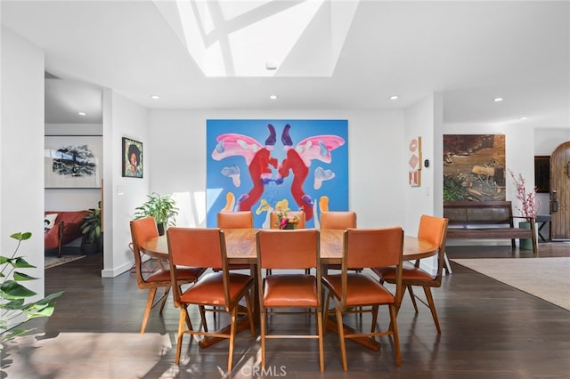 dining room with recessed lighting, a skylight, and wood finished floors