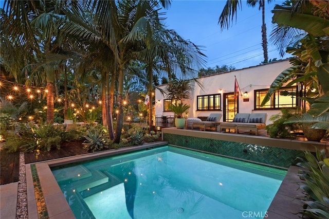 outdoor pool with an outdoor living space