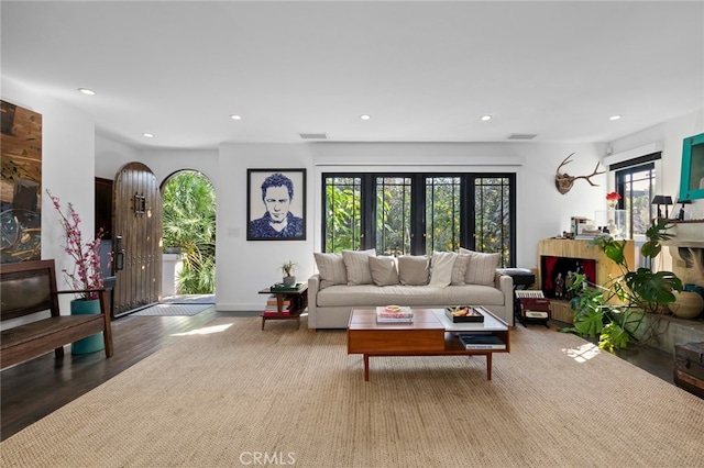 living area with wood finished floors, recessed lighting, and baseboards