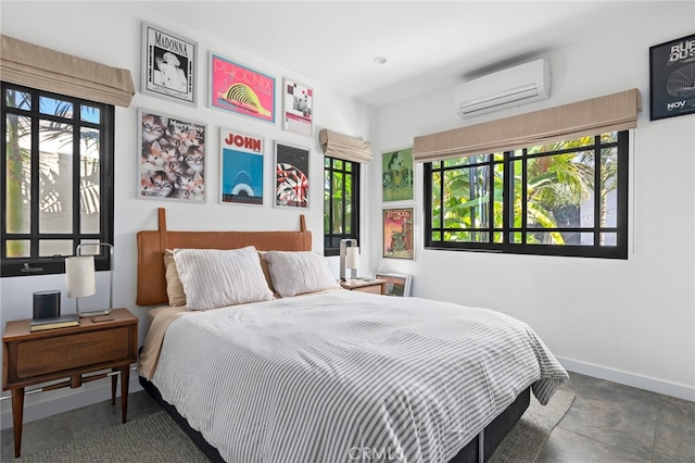 bedroom featuring baseboards and a wall mounted AC