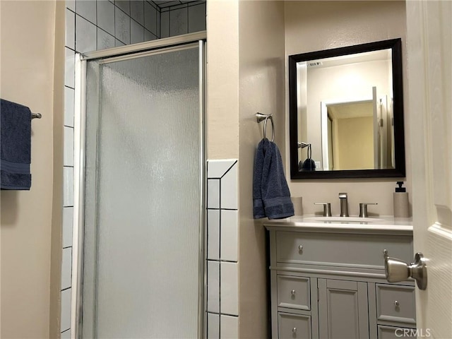 full bathroom with a shower stall and vanity