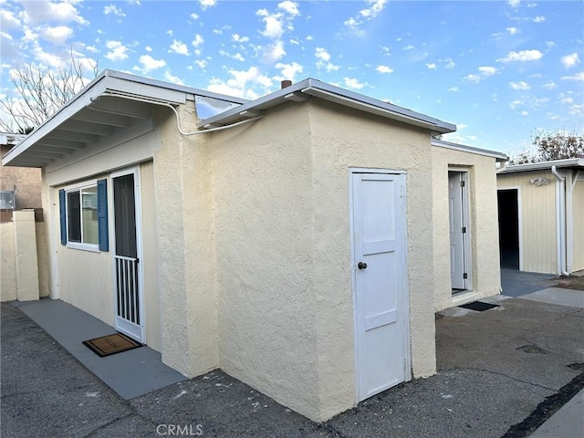 view of side of home featuring stucco siding