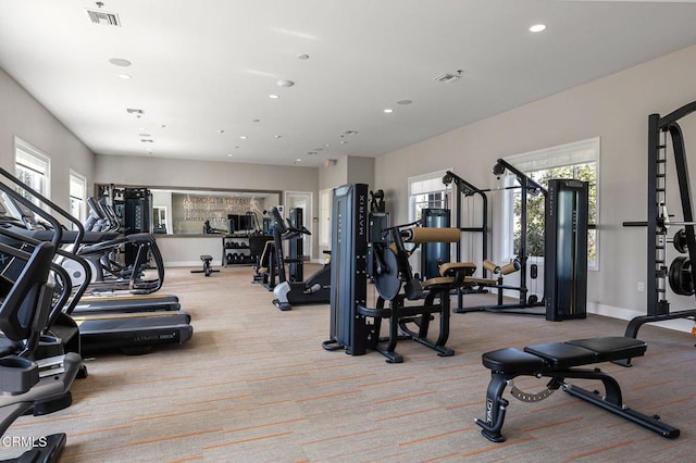 gym featuring a wealth of natural light, carpet flooring, and visible vents