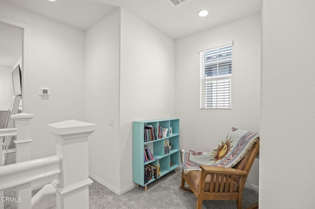 living area featuring recessed lighting, carpet, baseboards, and an upstairs landing