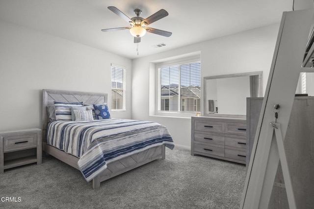 bedroom with carpet, visible vents, and a ceiling fan